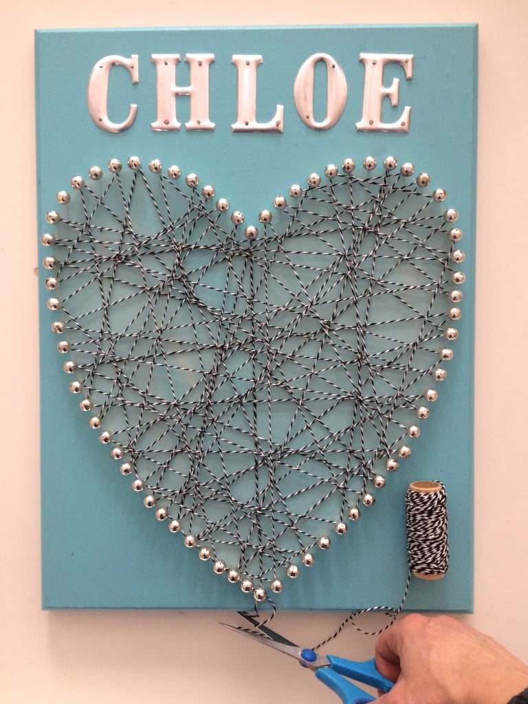 DIY valentines day memo board using push pins, twine and metal letters