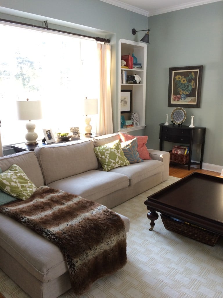Arhaus sectional neutral sofa with a big furry faux animal print blanket