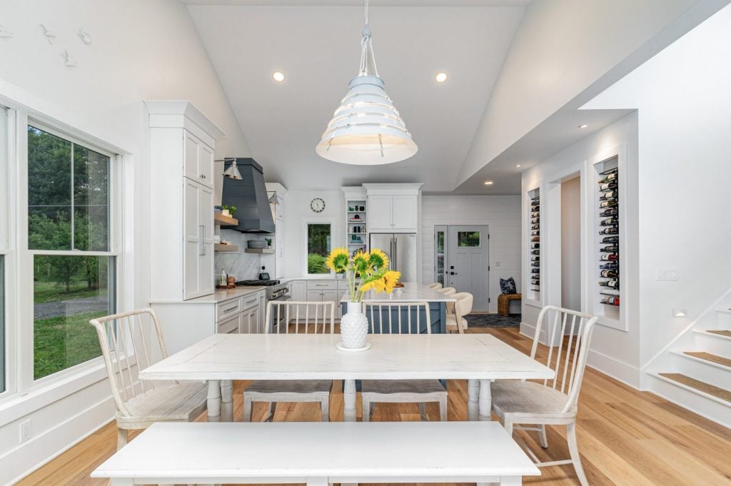 Progress Lighting Surfrider Pendant as the centerpiece over a dining table with vaulted ceilings.