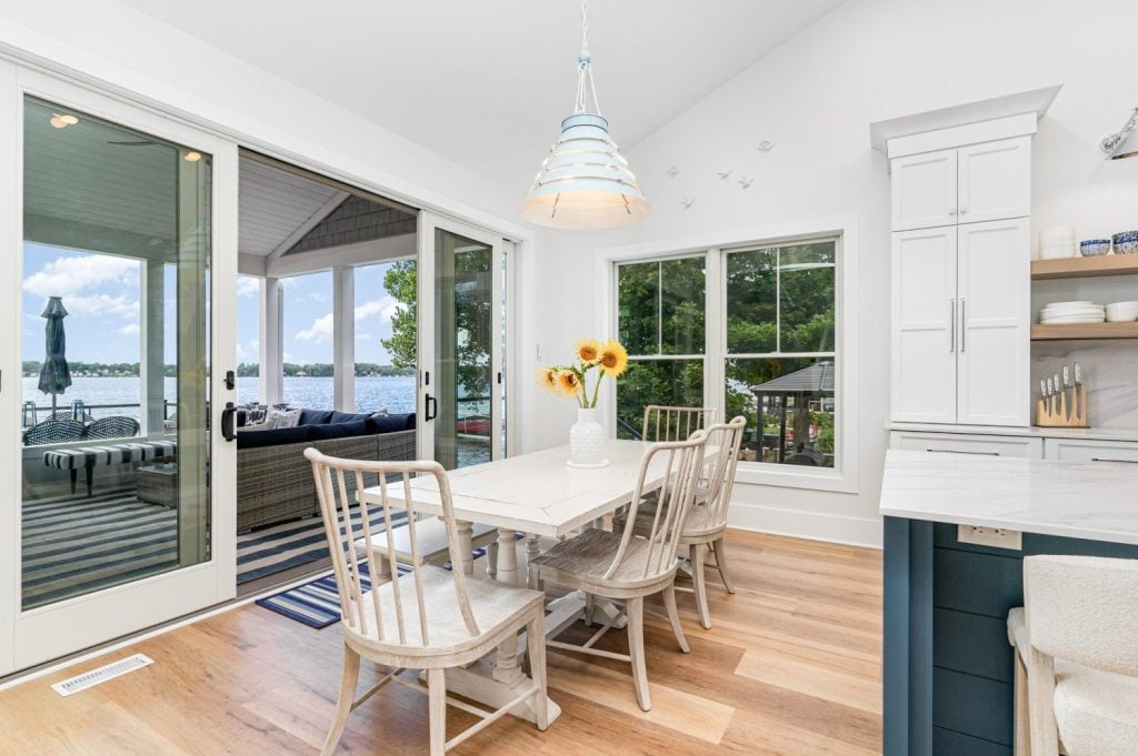Progress Lighting Surfrider Pendant hanging in a modern lake house kitchen with matching appliances.