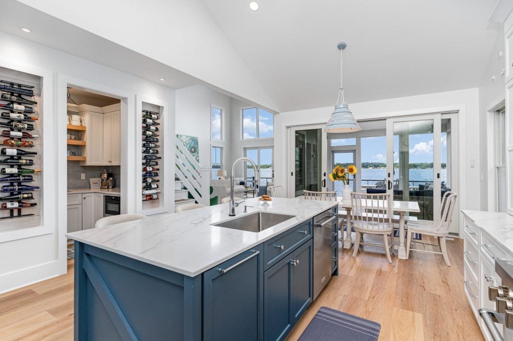 Dimmable Surfrider Pendant by Progress Lighting glowing softly at night over a family dining space.
