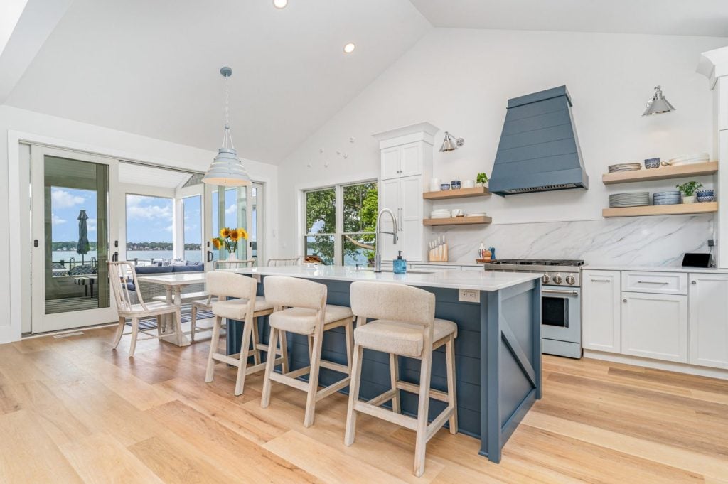 Lake house entry view showcasing the Progress Lighting Surfrider Pendant with Everlume Recessed Lights in ceiling.