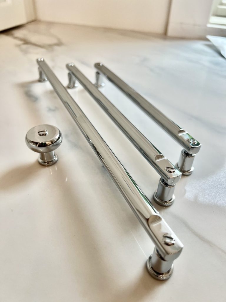 Luxury lakefront kitchen by Meme Hill Studio highlighting Atlas Homewares Everitt Collection polished chrome pulls and coordinating knobs