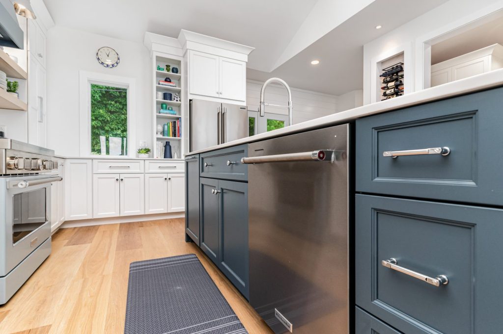 Angle view of kitchen island with Atlas Homewares Everitt Collection polished chrome cabinet hardware paired with quartz countertops