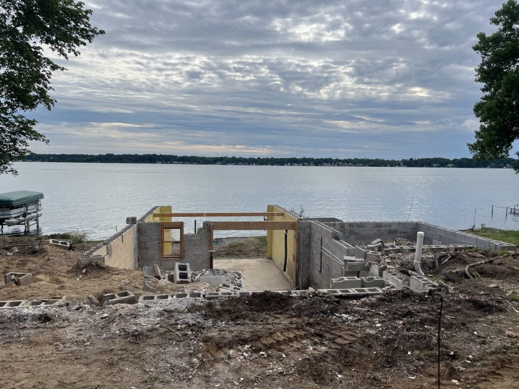 The complete demolition of a home on Cayuga Lake with just the basement foundation remaining