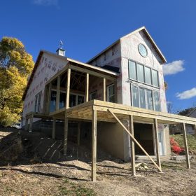 the lake side view of a new construction home being built on Cayuga Lake