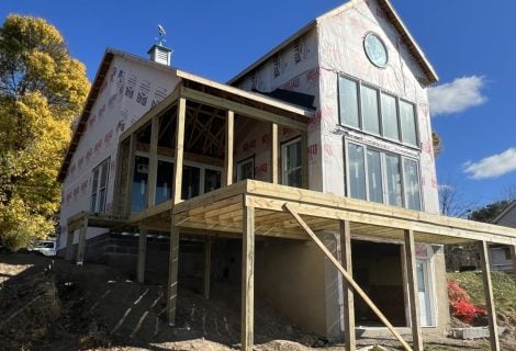 the lake side view of a new construction home being built on Cayuga Lake