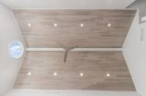 “Wide view of Havwoods Alabastro European Oak Ceiling installation with recessed lighting and contemporary ceiling fan.”