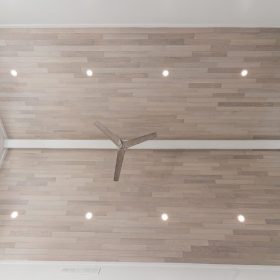 “Wide view of Havwoods Alabastro European Oak Ceiling installation with recessed lighting and contemporary ceiling fan.”