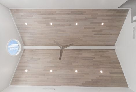 “Wide view of Havwoods Alabastro European Oak Ceiling installation with recessed lighting and contemporary ceiling fan.”