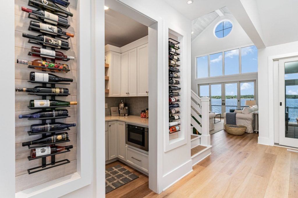 “Custom wine wall featuring Havwoods Alabastro European Oak planks reused from ceiling installation to tie design spaces together.”
