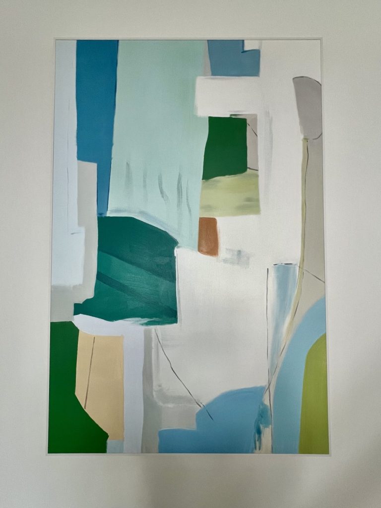 Affordable hand-painted art from Vinchy Art shown in a close-up view, featuring a vertical abstract painting in blue, turquoise, green, and beige tones.